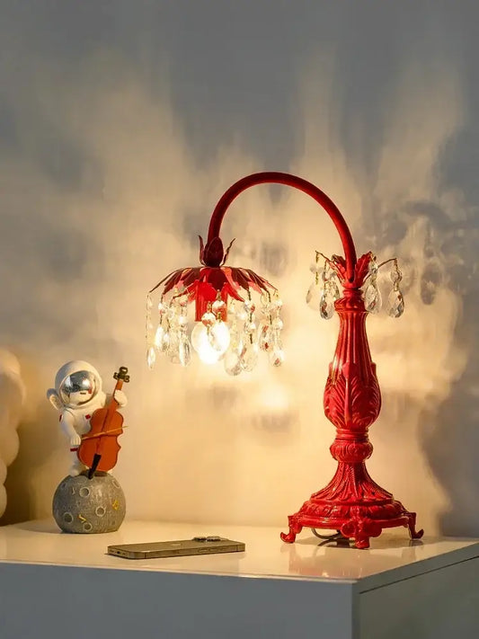 A vibrant red decorbites elegant crystal wedding table lamp with ornate curved neck and chandelier-style shade