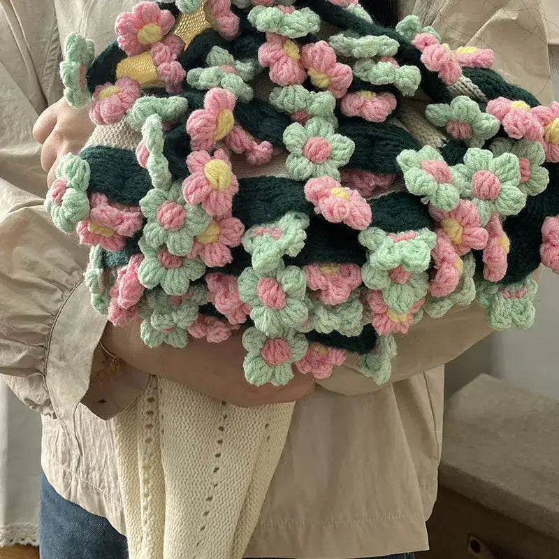 A decorbites elegant daisy bouquet soft knitted blanket with pink and mint flowers crafted from cozy yarn material