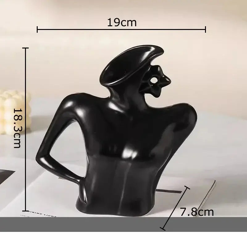 Black glossy ceramic vase figure of a stylized human form wearing a hat from elegant dames ceramic decor