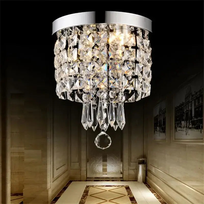 A sleek modern elegant diamond crystal led ceiling chandelier with polished chrome rim and cascading glass prisms for living room