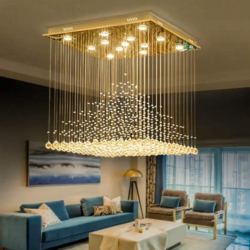 Golden square chandelier with cascading clear and amber crystal strands and teardrop pendants for decorbites elegant duplex villa hotel lobby light