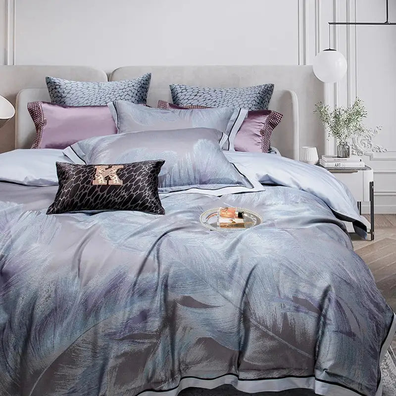 Luxurious silver-gray satin feather patterned duvet cover with black trim and coordinating lavender and gray pillows in a 1500tc egyptian cotton silk bedding set
