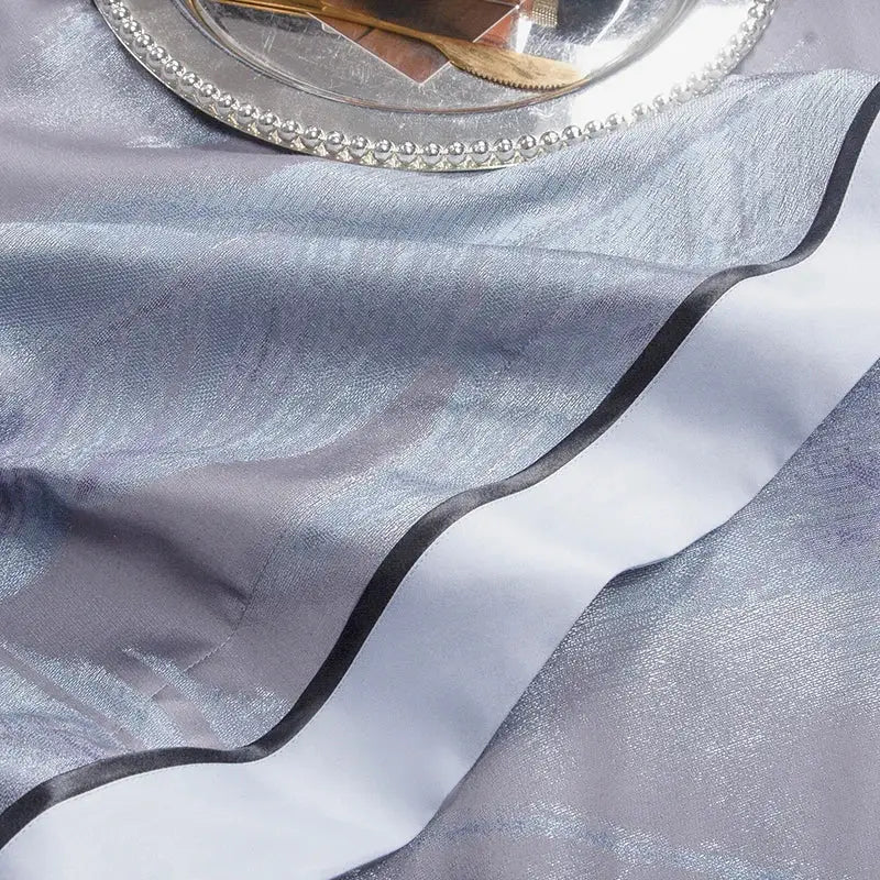 Silver metallic table runner with black satin trim complements elegant feather gray 1500tc egyptian cotton silk bedding set
