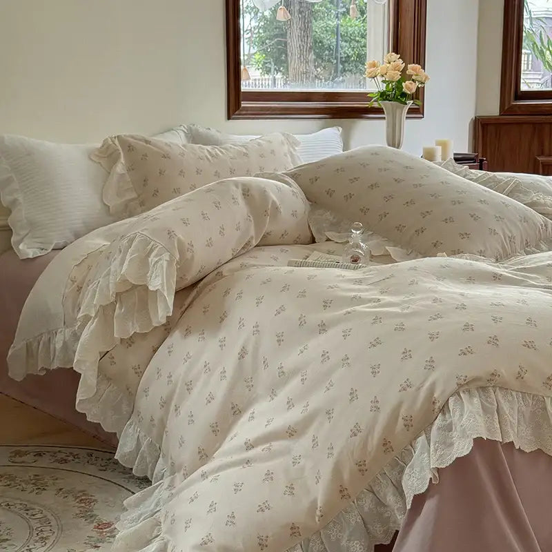 Cream-colored bedding set featuring elegant floral lace ruffles with delicate prints and layered lace detailing