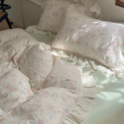 Elegant floral lace ruffles bedding set featuring a delicate ivory floral duvet with lace trim and soft ruffled edges