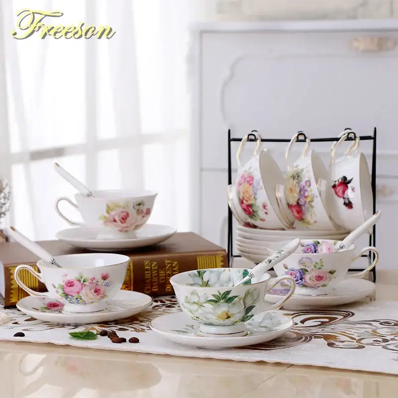 Elegant floral porcelain tea cup set with gold trim featuring delicate pink purple and green patterns for dining room use