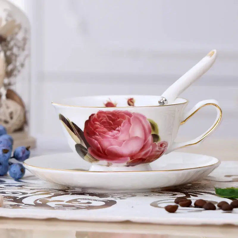 Elegant floral porcelain tea cup set with delicate white cup featuring hand-painted pink peony and gold trim on saucer