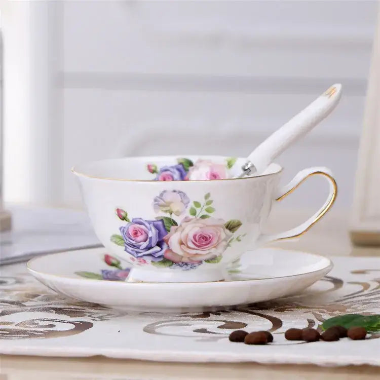 Elegant floral porcelain tea cup set featuring delicate white cups with hand-painted pink and purple roses and gold trim