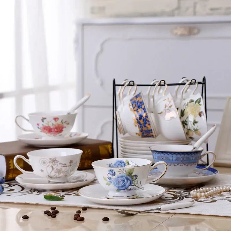Elegant white porcelain tea cup set with blue rose design and gold trim featuring matching saucer for dining room use