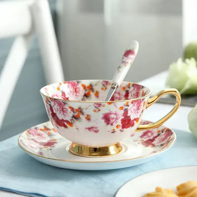 A delicate porcelaine tea set with pink and orange floral pattern and gold trim from decorbites elegant floral tea collection