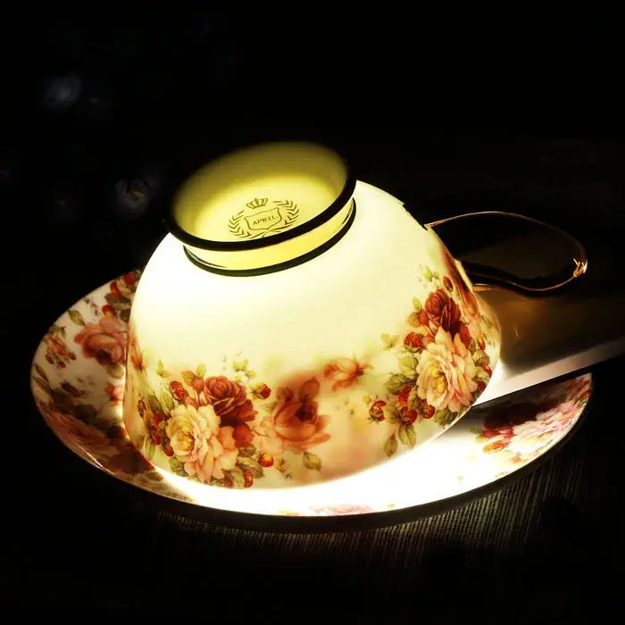 A delicate bone china teacup with a warm floral pattern and gold rim from decorbites elegant floral tea set april edition
