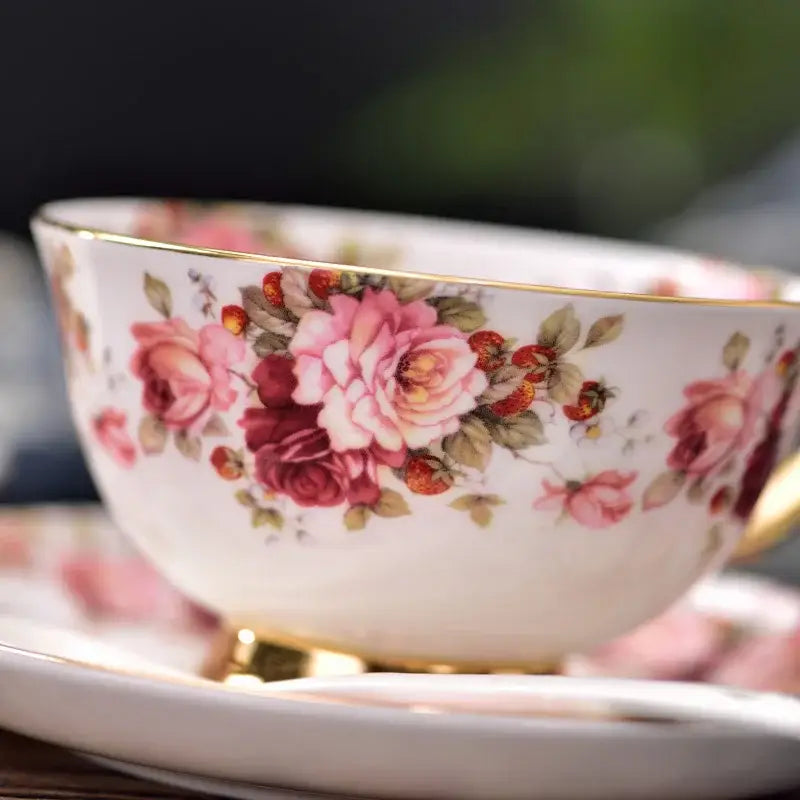 A delicate pink and orange bone china teacup from decorbites elegant floral tea set with intricate rose blossoms and gold trim
