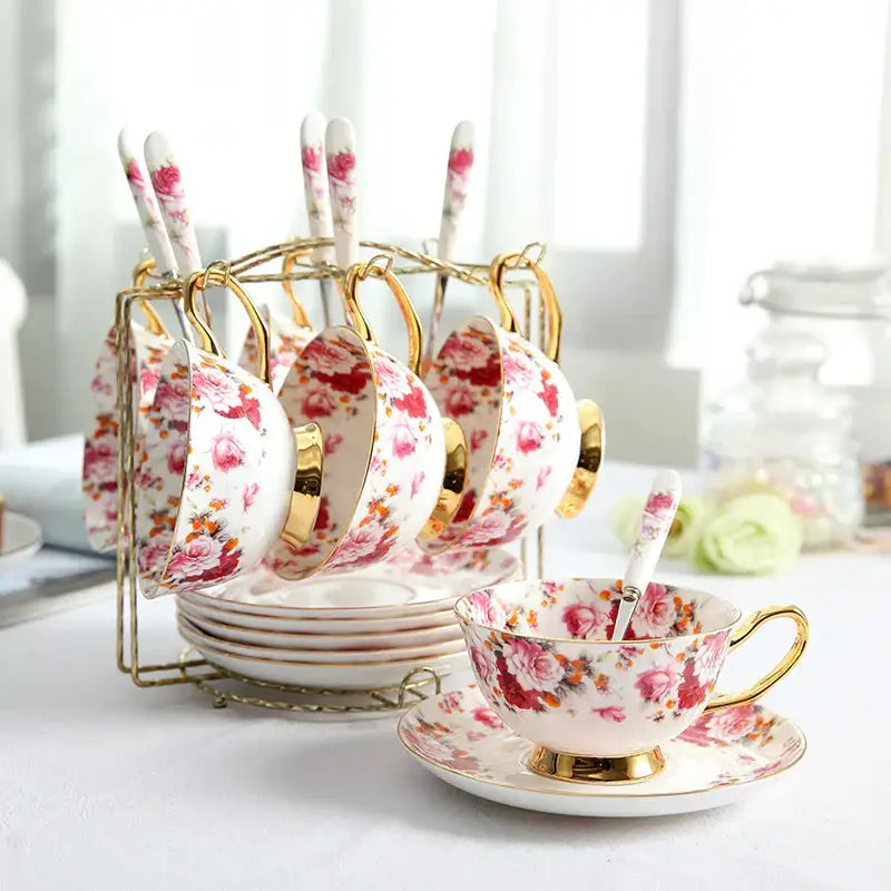 A delicate bone china elegant floral tea set featuring a pink and orange floral porcelain cup with gold trim