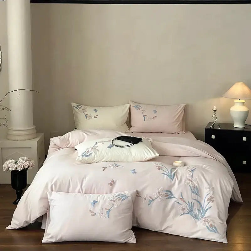 Pastel pink satin bedding set with elegant flower embroidery in blue and white thread for decorbites elegant flower decor