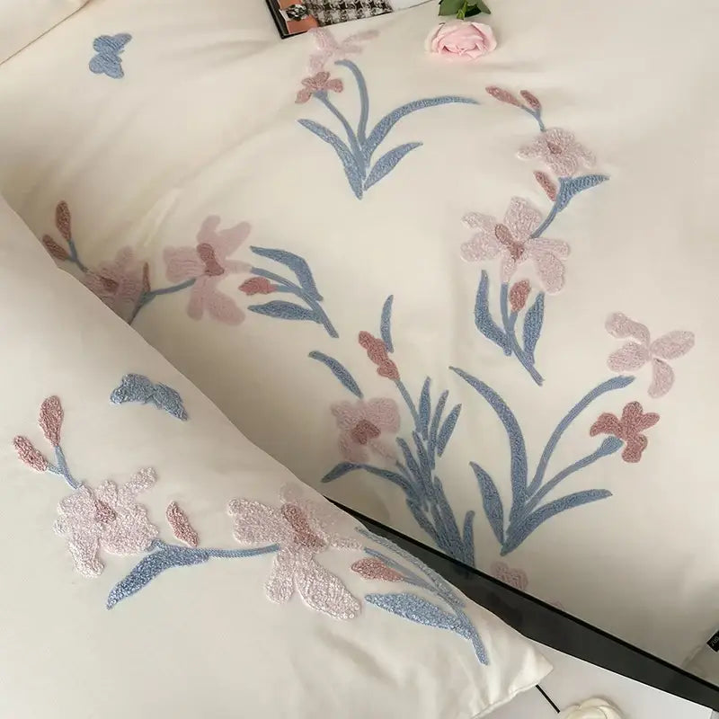 Cream-colored satin pillowcase with delicate pink and blue floral embroidery from decorbites elegant flower bedding set