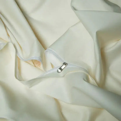 Cream satin bedding set with elegant flowers embroidery and smooth texture featuring a silver zipper pull