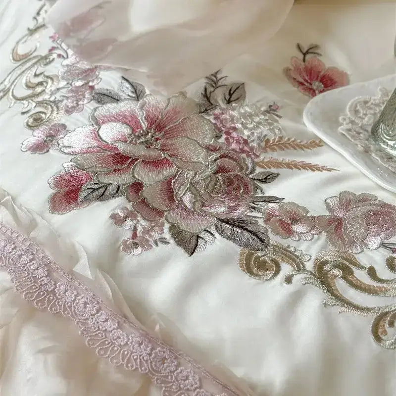 A delicate white satin bedding set with pink and silver elegant flowers embroidery and matching lace trim decorbites elegant flowers