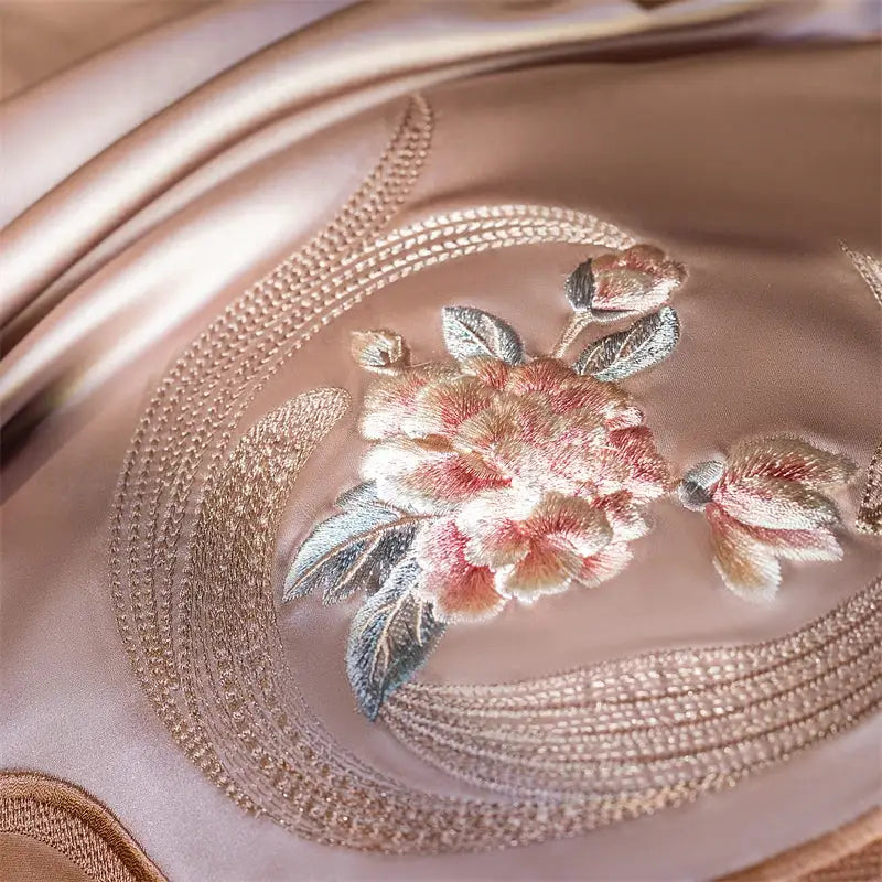A delicate rose embroidery in soft pink and silver thread on satin fabric of decorbites elegant flowers bedding set