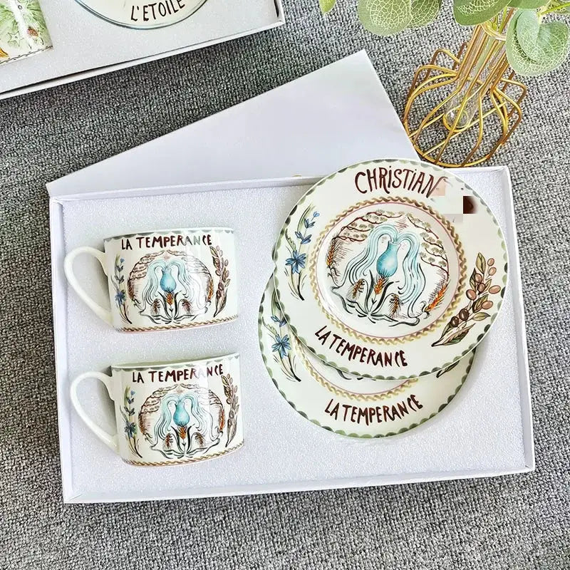 White ceramic plate with hand-painted blue figure and floral motifs from elegant geometric bone china tea cup set