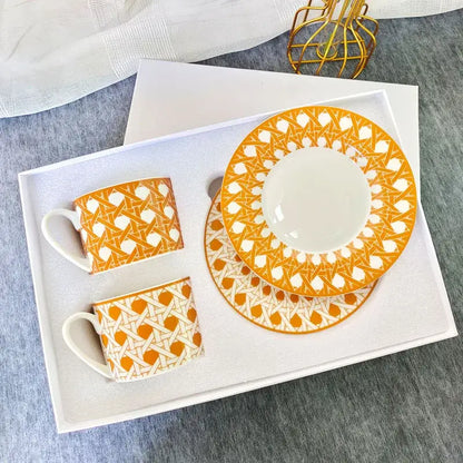 Elegant orange and white geometric bone china tea cup set with matching ceramic saucer for dining room use