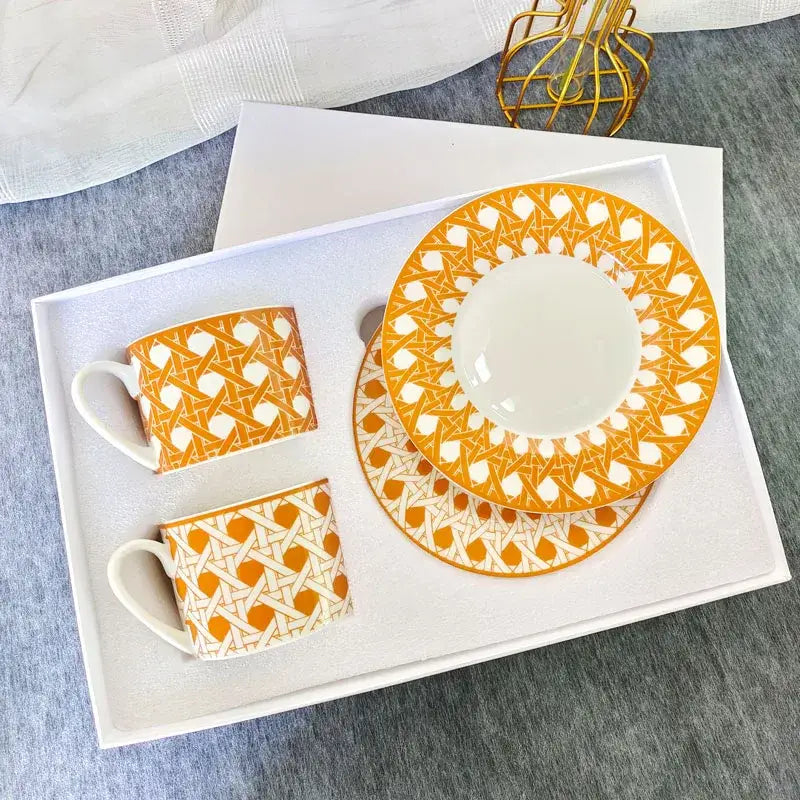 Elegant orange and white geometric bone china tea cup set with matching ceramic saucer for dining room use