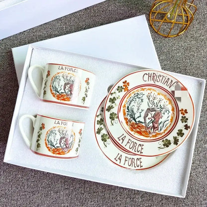 Elegant white bone china tea cup set with hand-painted deer floral motifs and la force christian lacroix inscriptions