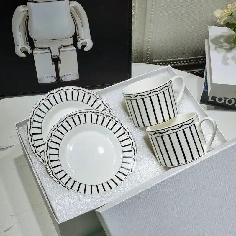 Elegant geometric bone china tea cup set in white with black stripes and decorative borders for dining room use