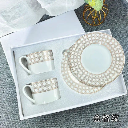 Elegant white bone china tea cup set with delicate gold geometric lattice patterns on rim and cup bands