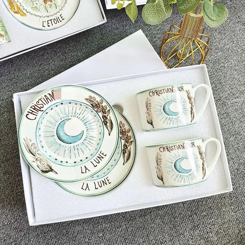 White ceramic bone china tea cup set with hand-painted blue crescent moon botanical motifs and christian dior branding