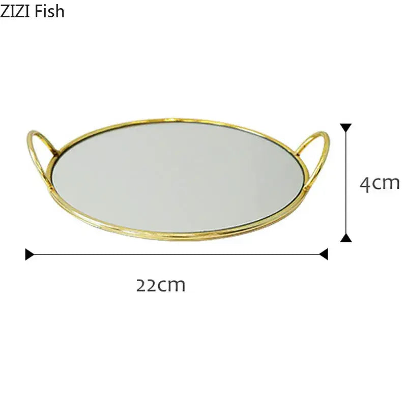Gold-toned oval mirror tray with two loop decorbites brass handle storage handles measuring 22cm by 4cm