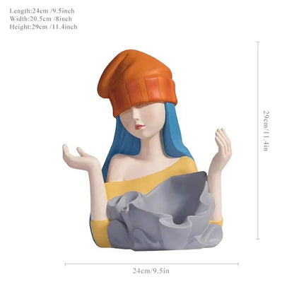 Stylized resin decorbites elegant girl sculpture with blue hair orange beanie holding gray fabric wine rack for dining decor