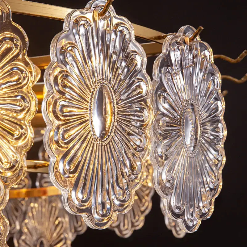Elegant glass chandelier with clear cut glass sunburst shades and gold-toned metal accents by decorbites elegant glass