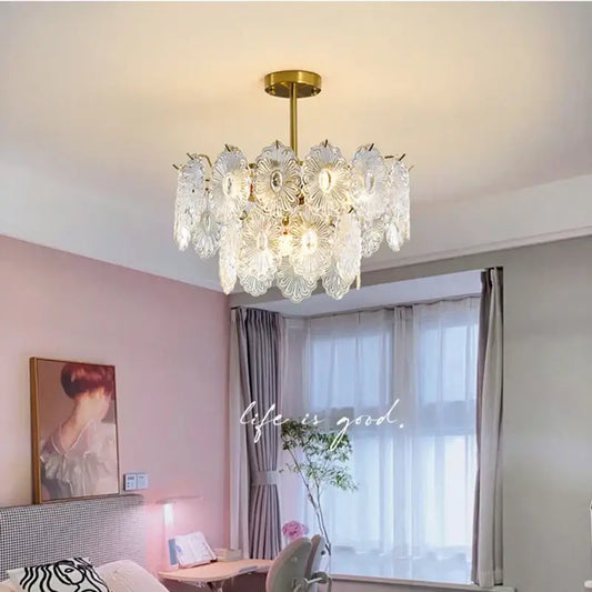 A decorbites elegant glass chandelier with gold-toned metal frame and petal-shaped shades for dining room lighting