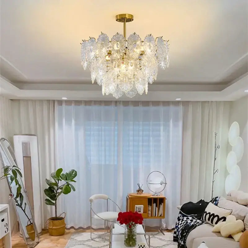 Elegant glass chandelier by decorbites featuring gold finish and cascading clear glass petals for dining room decor