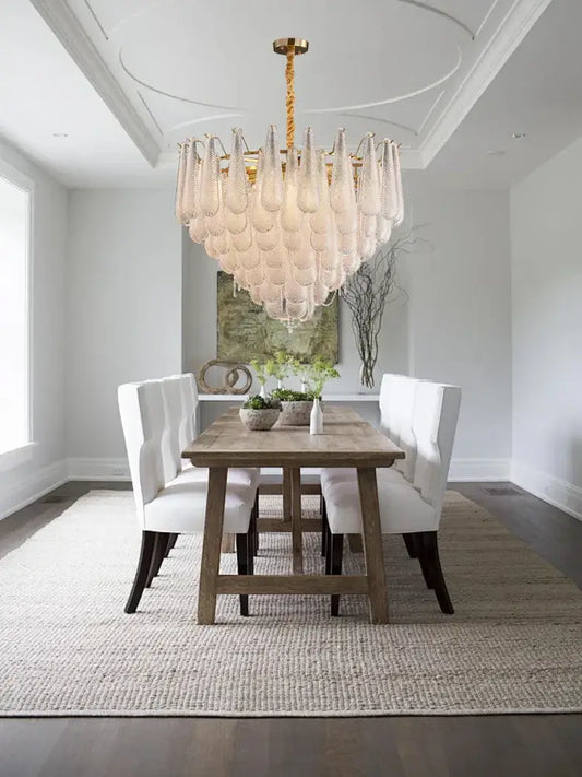 A decorbites elegant glass chandelier with gold finish and translucent teardrop glass shades for dining room lighting