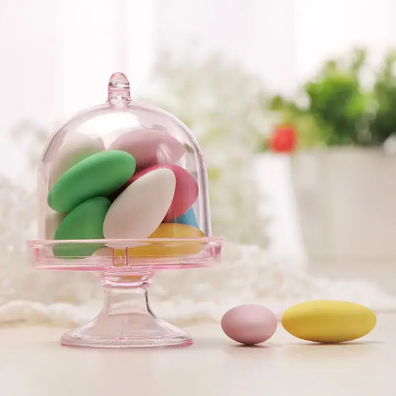 Elegant translucent pink glass candy box tray with domed lid holding colorful decorbites candy box favors