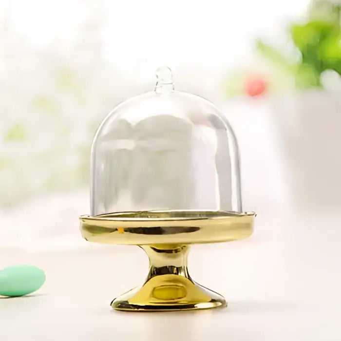 Elegant gold-colored glass dome candy box tray with a polished metallic base for dining room party favors decorbites candy box