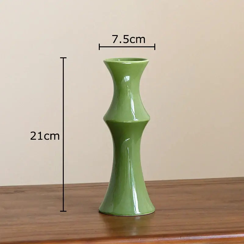 A sleek glossy sage green bamboo ceramic vase with a slender fluted design for elegant decorbites bamboo decor