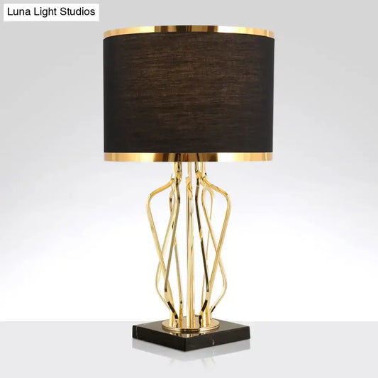 Elegant gold-toned decorbites™ simplicity drum nightstand lamp with black fabric shade and black marble base for led use