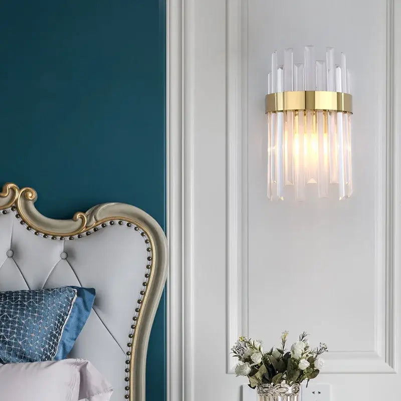 Elegant gold and crystal led wall lamps with vertical rods providing warm light for living space decor