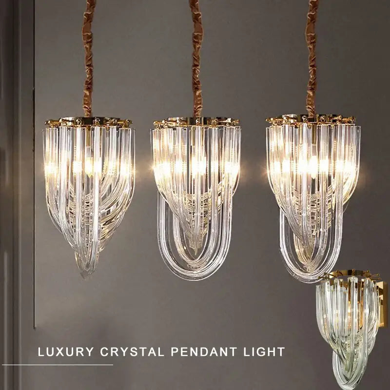Three elegant glass crystal pendant lights with gold metal accents and twisted copper chains for kitchen island lighting