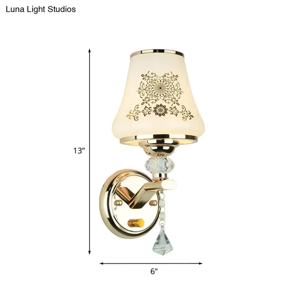Elegant gold finished wall light with cream ornate glass shade and crystals ideal as a single reading wall light