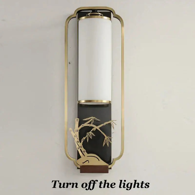 Elegant gold bamboo iron glass wall sconce with white cylindrical shade and black base for living room lighting
