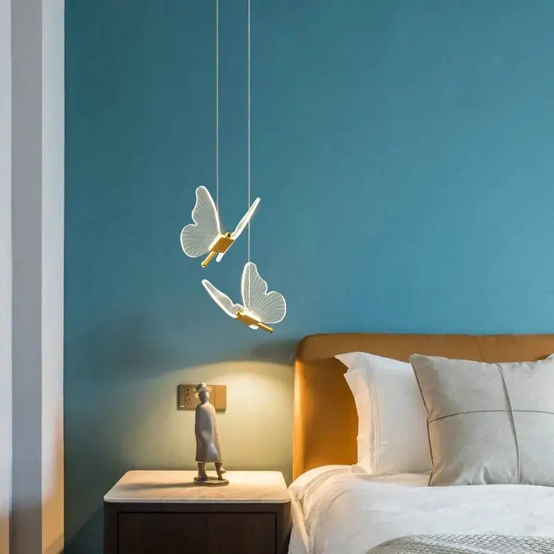Delicate white butterfly pendant lamp with gold accents hanging from thin cords decorbites butterfly pendant lamp