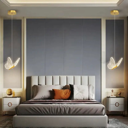 Elegant gold butterfly pendant lamp with modern glowing white wings and gold accents hanging above the bed decorbites butterfly pendant
