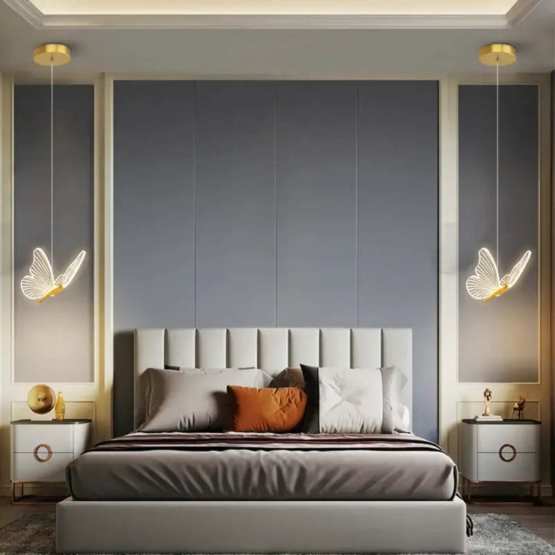 Elegant gold butterfly pendant lamp with modern glowing white wings and gold accents hanging above the bed decorbites butterfly pendant