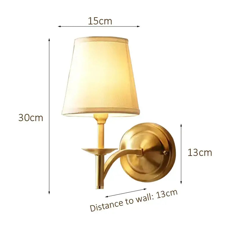 Brass-finished wall lamp with a tapered beige fabric shade ideal for elegant bedroom decorbites copper wall lamp