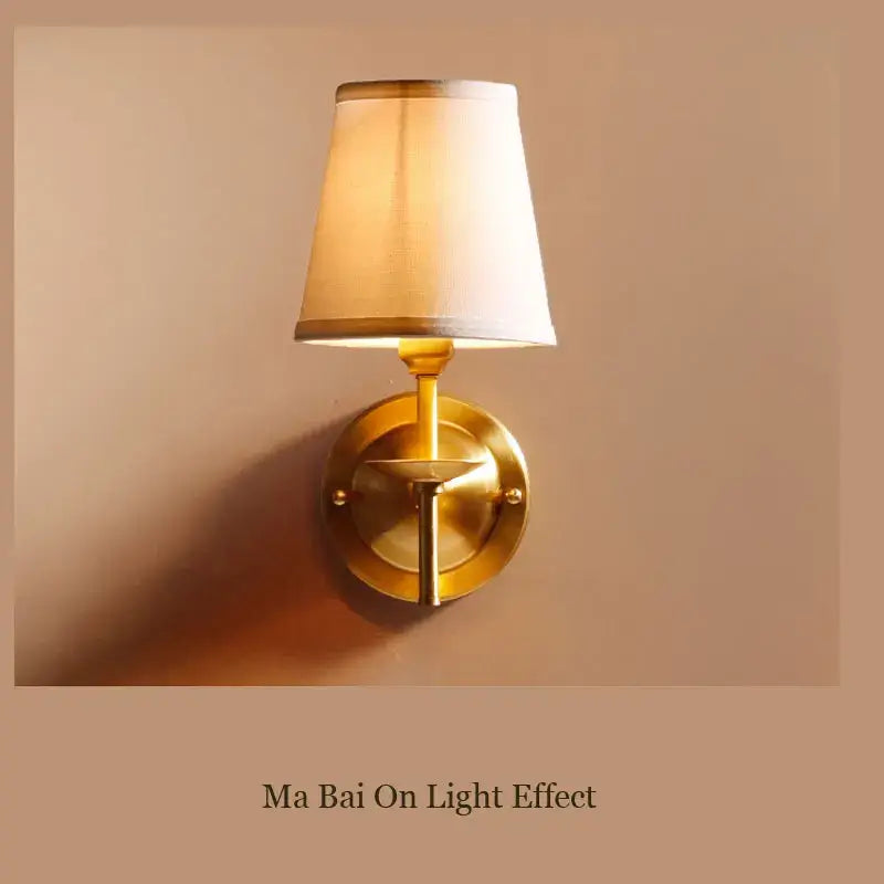 A warm-toned brass wall lamp with a tapered cream fabric shade ideal for elegant bedroom decorbites copper wall lamp
