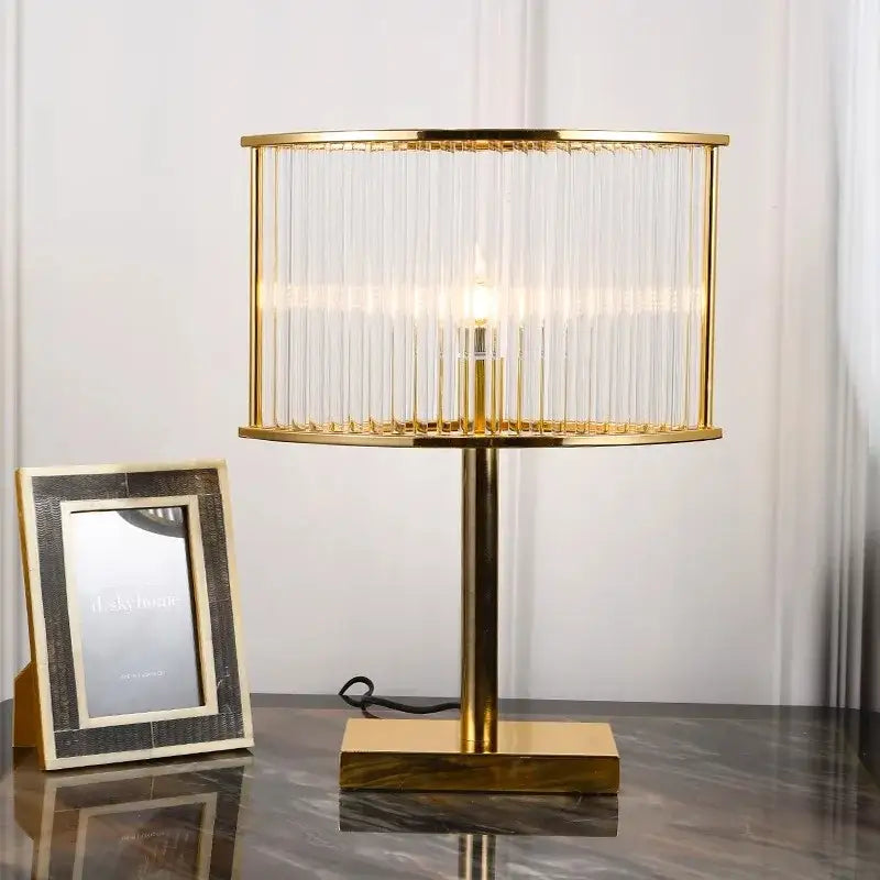 Elegant gold-toned table lamp with cylindrical glass shade and vertical crystal prisms decorbites crystal bar table lamp
