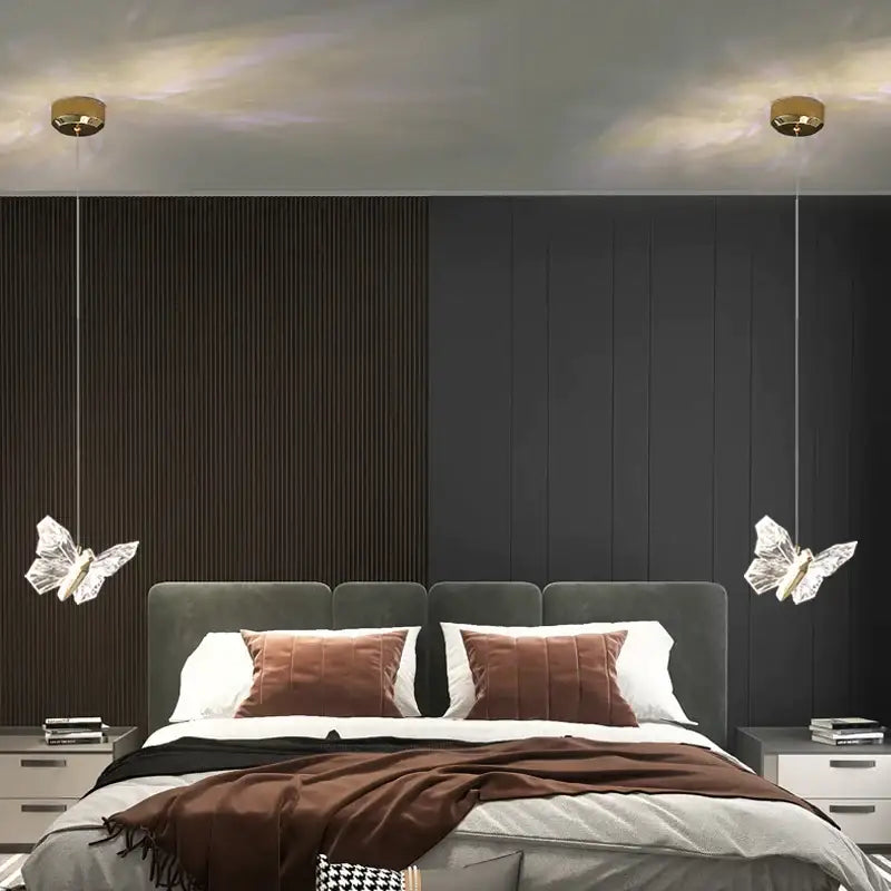 Elegant gold crystal butterfly ladder pendant lights with gold-toned fixtures hanging above a bed for decorbites butterfly ladder decor